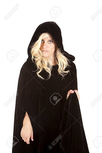 14610369-a-woman-wearing-her-black-cape-with-a-serious-expression-on-her-face-