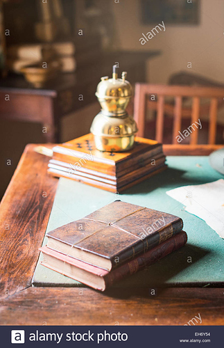 old-books-lying-on-the-dusty-table-EH6Y54